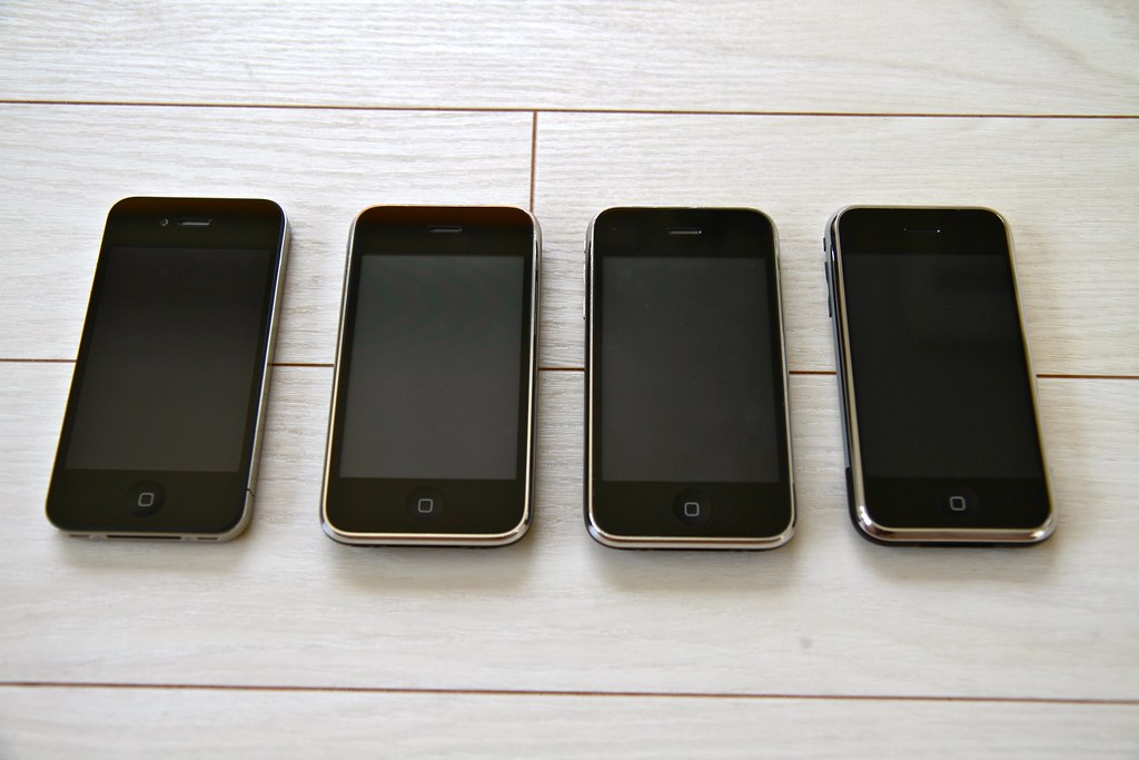 Four different generations of iPhone are shown. The are arranged left to right, newest generation to oldest. 